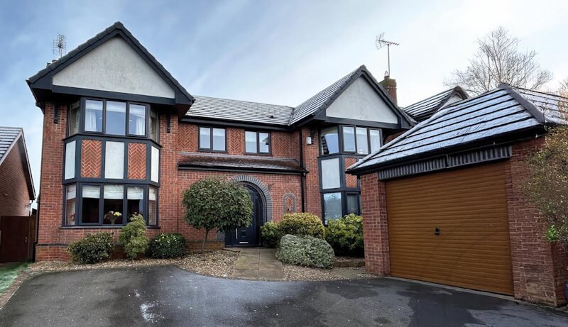house with brown window frames